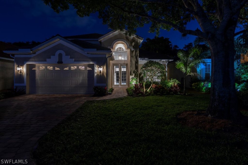 8856 Ventura Way Naples, FL 34109 - Photo 3 of 34 a front view of a house with a garden