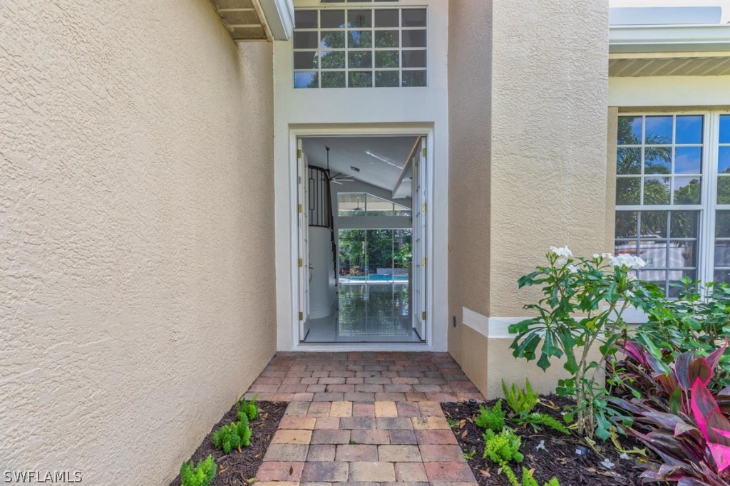 8856 Ventura Way Naples, FL 34109 - Photo 4 of 34 a view of front door of a house with a yard