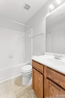 a bathroom with a sink a toilet and a shower