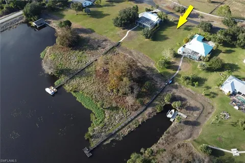 an aerial view of residential houses with outdoor space and lake view