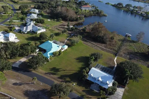 an aerial view of a house with a yard