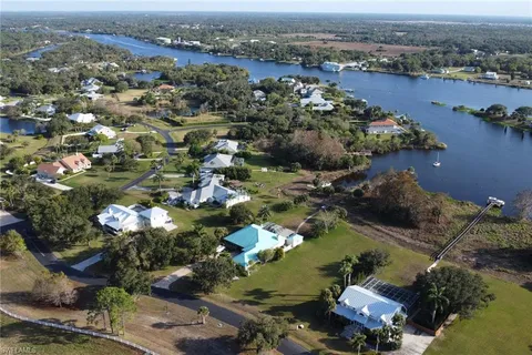 an aerial view of a houses with a lake view