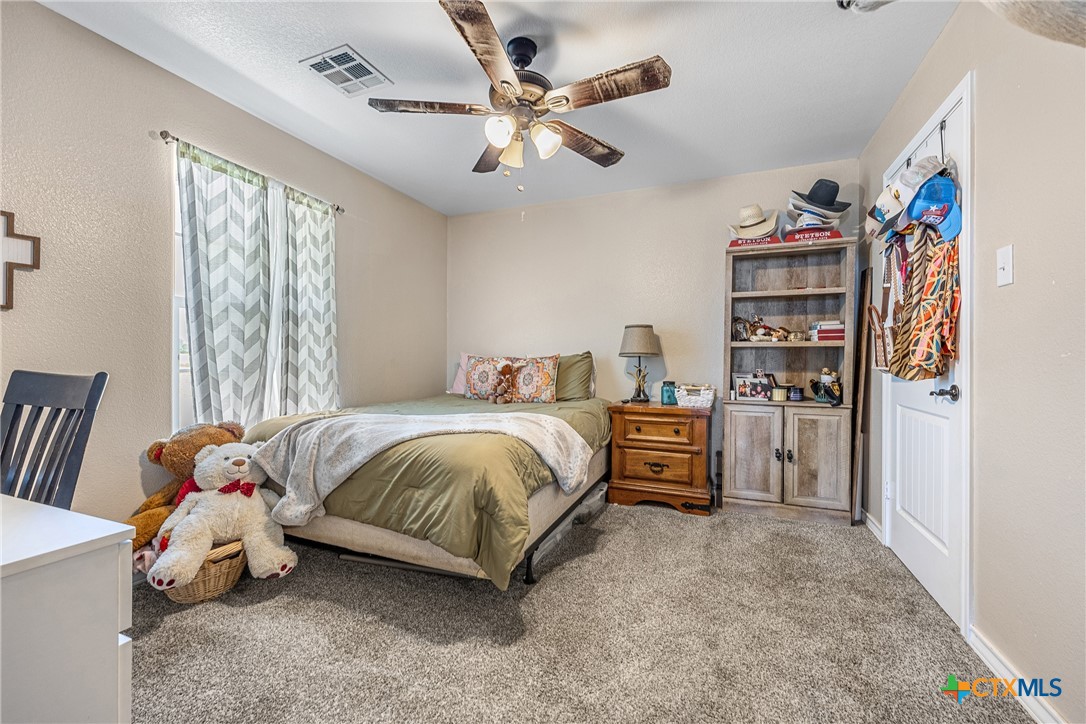 16101 Dove Road Moody, TX 76557 - Photo 23 of 42 a bedroom with a bed and a chandelier