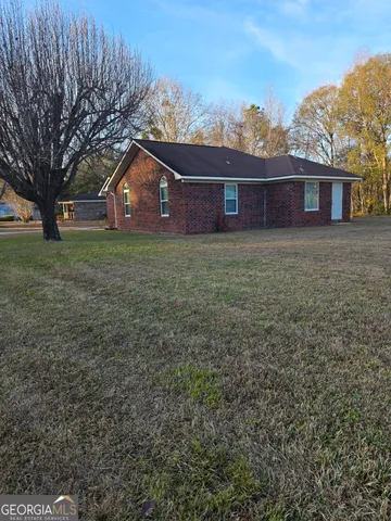 a front view of house with yard and trees