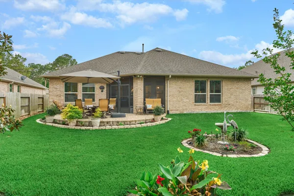 a view of a house with backyard and sitting area