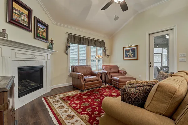 a living room with furniture a flat screen tv and a fireplace