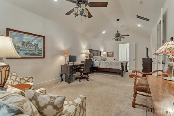 a living room with furniture a ceiling fan and a rug