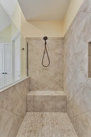 a bathroom with a double vanity sink a toilet and shower