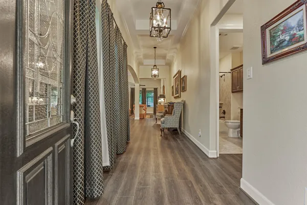 a view of a hallway and wooden floor windows