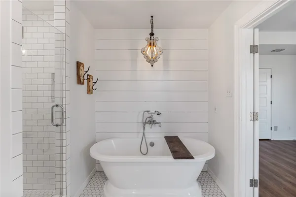 a bathroom with a sink a window and shower