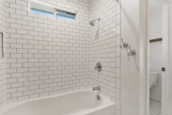 a bathroom with a bathtub and shower