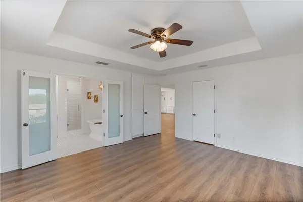 a view of an empty room and wooden floor