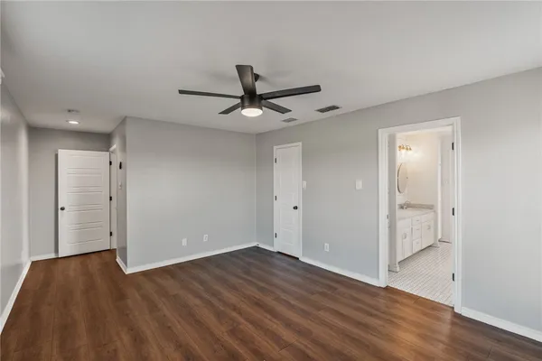 a view of an empty room and wooden floor