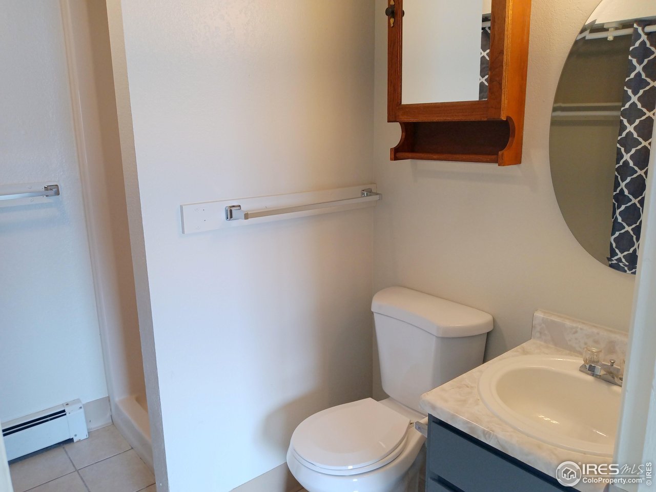 229 15th Street Greeley, CO 80631 - Photo 18 of 19 a white toilet sitting next to a bathroom sink