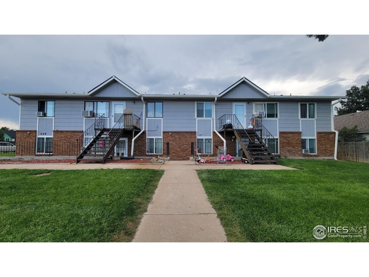229 15th Street Greeley, CO 80631 - Photo 2 of 19 a backyard of a house with table and chairs
