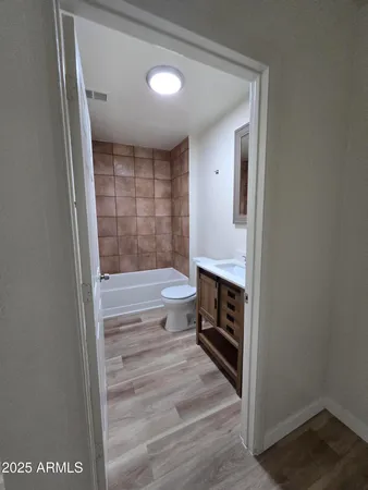 a bathroom with a toilet a sink and bathtub
