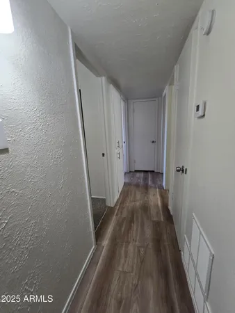 a view of a room with wooden floor