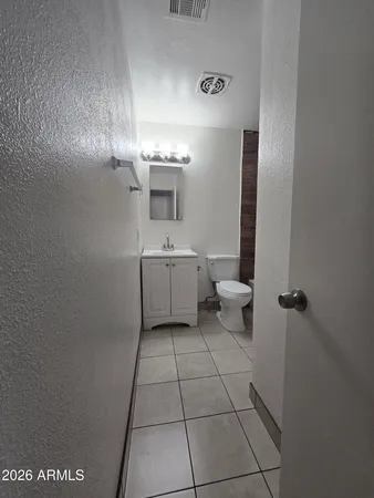 a bathroom with a sink a toilet and mirror