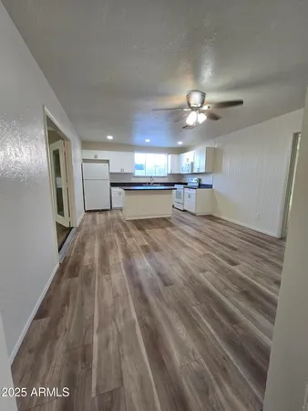 a view of a room with wooden floor