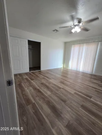 a view of a livingroom with a ceiling fan and window