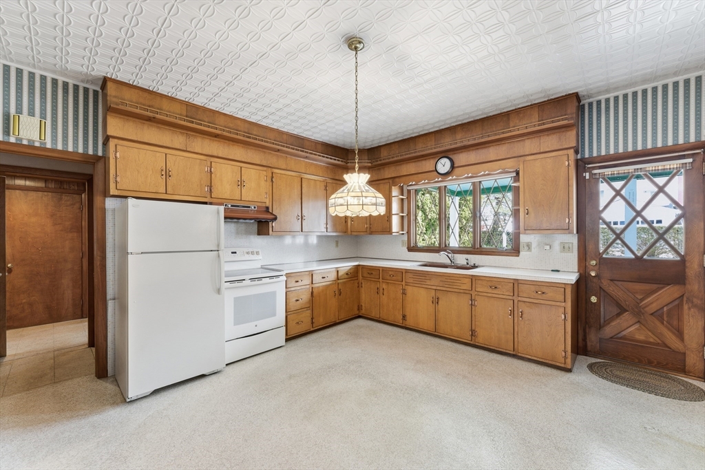 3 River Street Hardwick, MA 01031 - Photo 12 of 36 a kitchen with white cabinets and white appliances