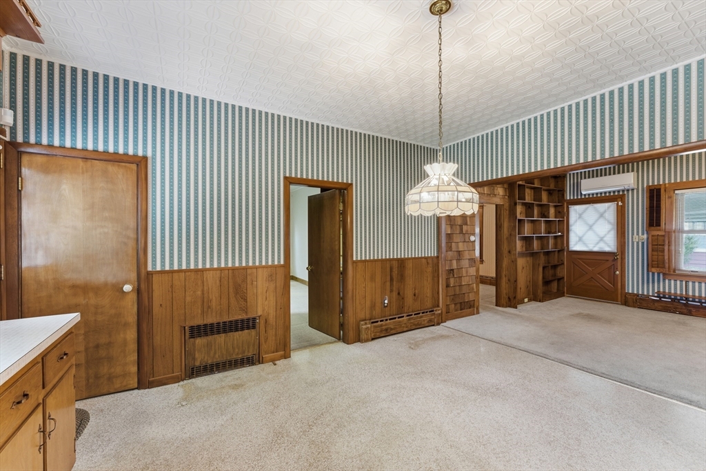3 River Street Hardwick, MA 01031 - Photo 14 of 36 a spacious bedroom with a bed and a chandelier