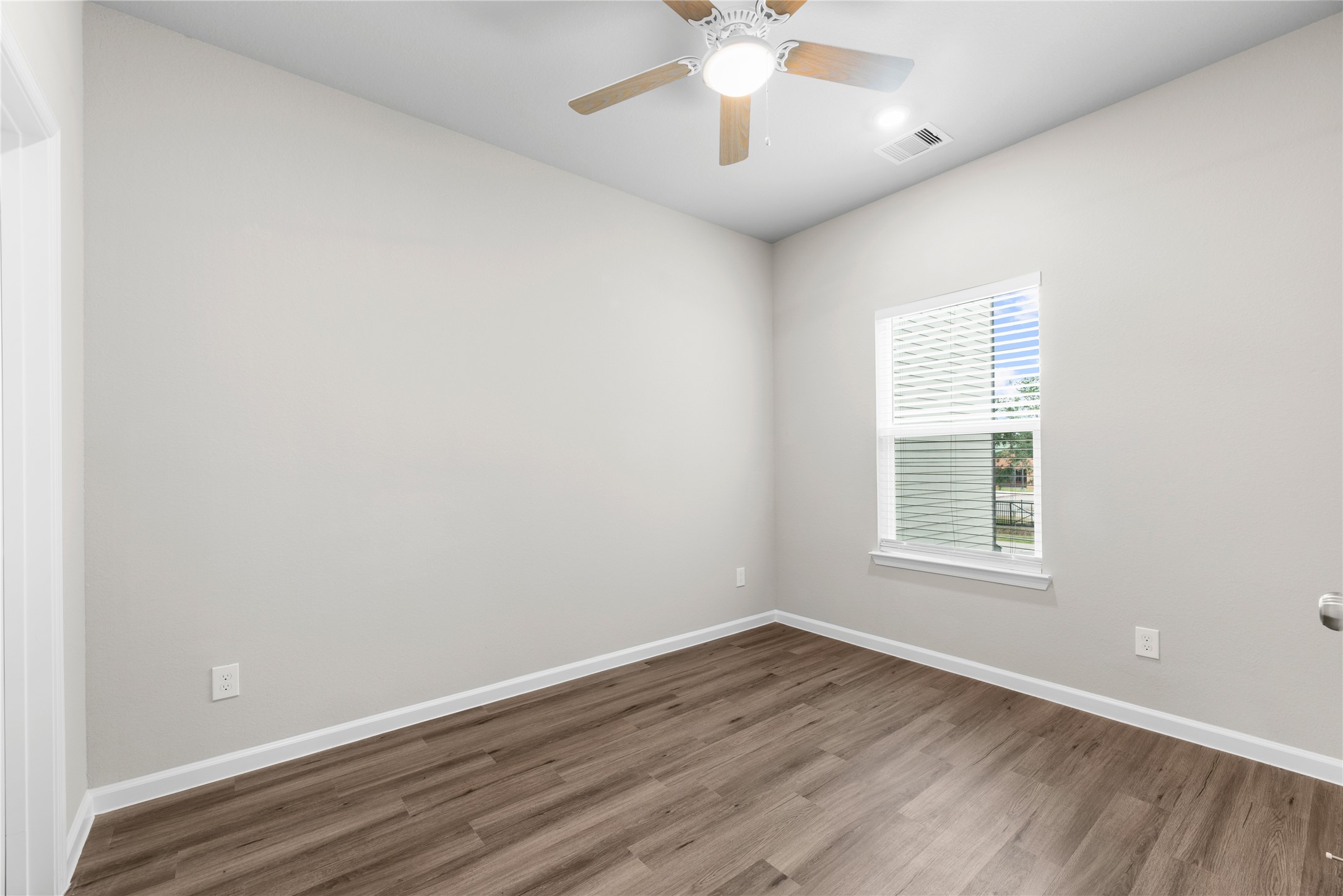8161 Tate Street, Unit B Houston, TX 77028 - Photo 10 of 14 an empty room with wooden floor and windows