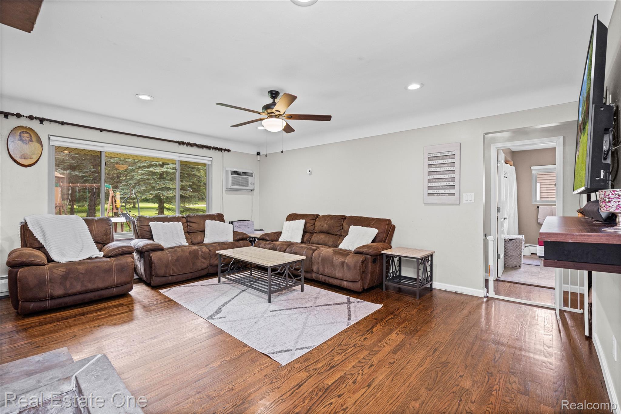 2810 Walbridge Drive Rochester, MI 48307 - Photo 7 of 58 Spacious living area featuring polished wood-finish flooring and ample natural light from a large window