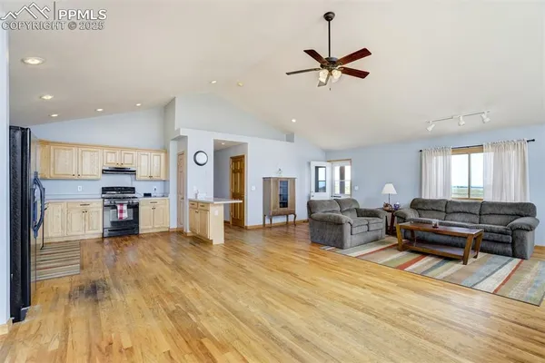 a living room with furniture and kitchen view