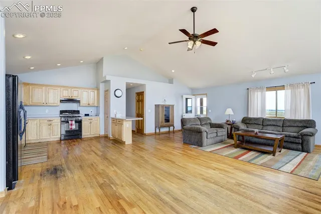 a living room with furniture and kitchen view