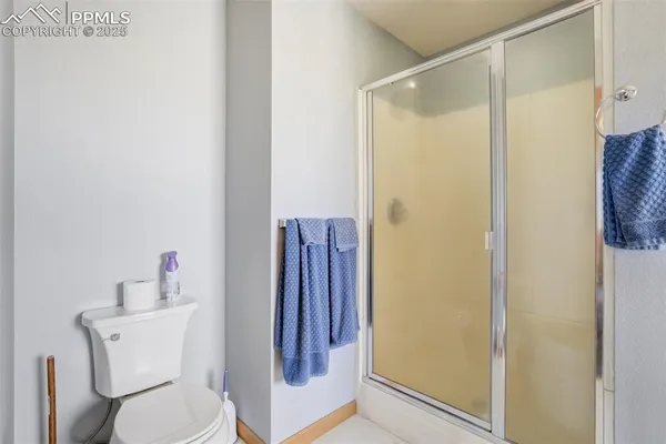 a bathroom with a shower toilet and sink