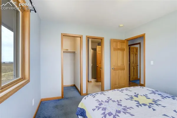 a bedroom with a bed and a mirror