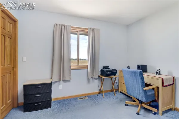 a workspace room with furniture and windows