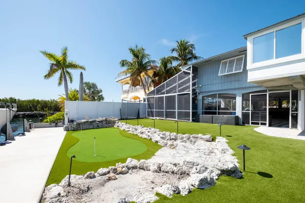 a living room with furniture a table and kitchen view