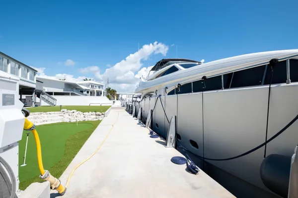 a kitchen with stainless steel appliances kitchen island granite countertop a table chairs and a refrigerator