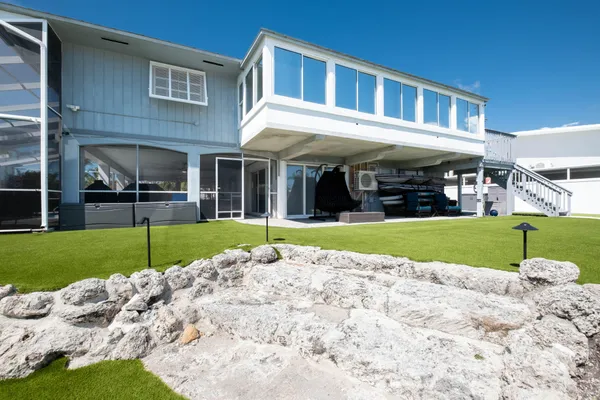 a bathroom with a granite countertop sink a mirror and a shower