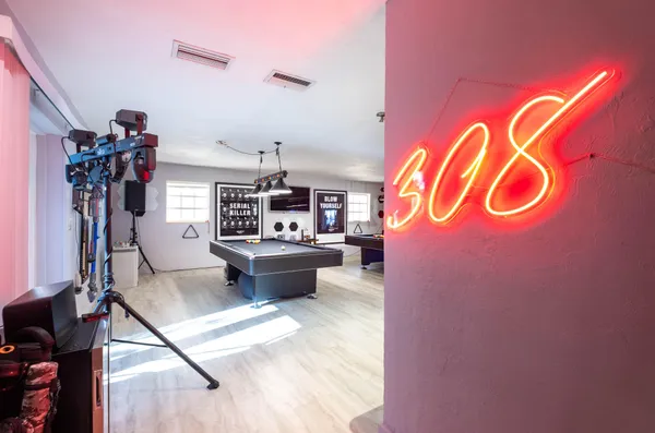 a view of a hallway with workspace and a window