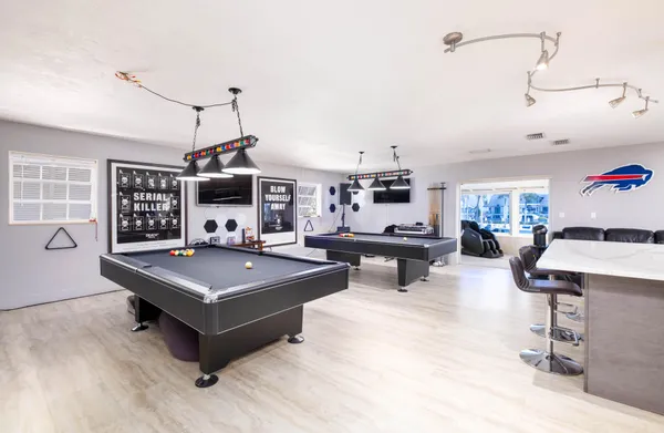 a view of dining room with wooden floor and cabinet