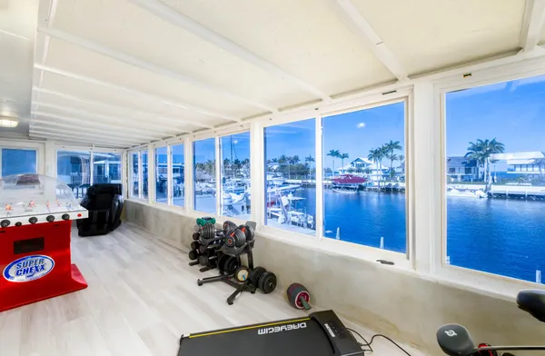 a living room with furniture a rug and a dining table with a kitchen view