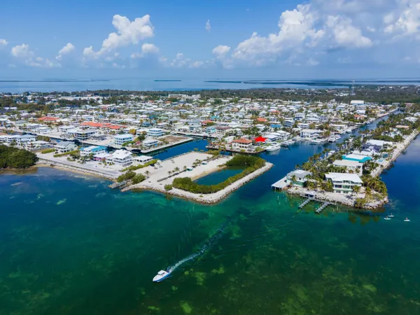 a view of a house with pool and chairs