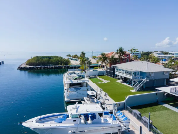 a view of a house with pool and chairs