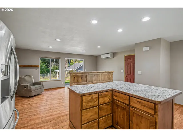 a kitchen that has a lot of cabinets and wooden floor