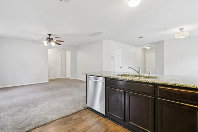 a spacious bathroom with a granite countertop sink