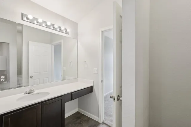 a bathroom with a double vanity sink a mirror and a bathtub