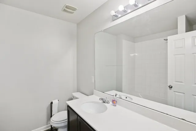 a bathroom with a glass shower door