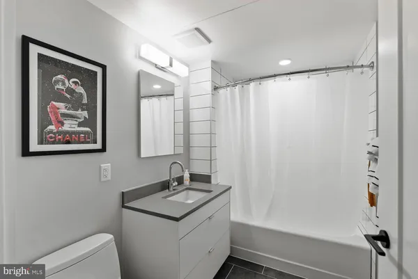 a bathroom with a shower sink and mirror