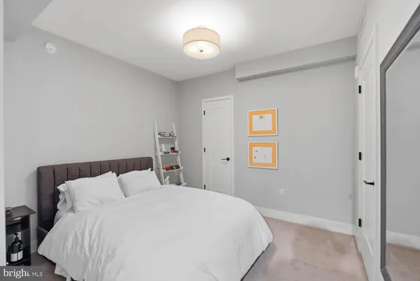 a bedroom with a bed and a lamp