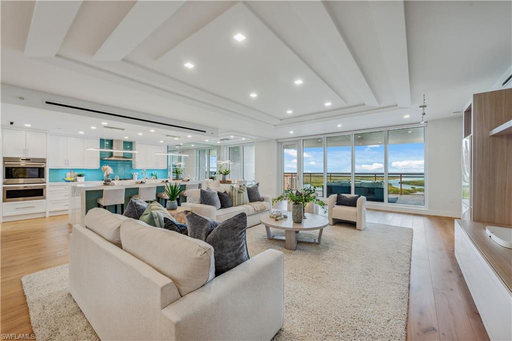 13915 Old Coast Road, Unit 1603 Naples, FL 34110 - Photo 1 of 37 a living room with furniture and a large window
