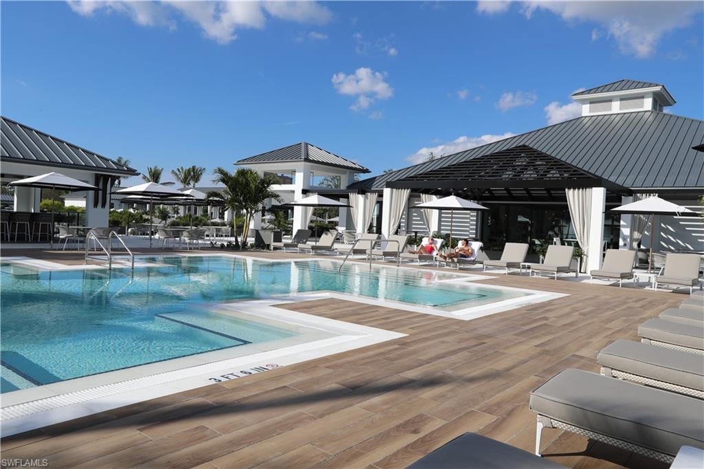 13915 Old Coast Road, Unit 1603 Naples, FL 34110 - Photo 32 of 37 a view of pool with outdoor seating