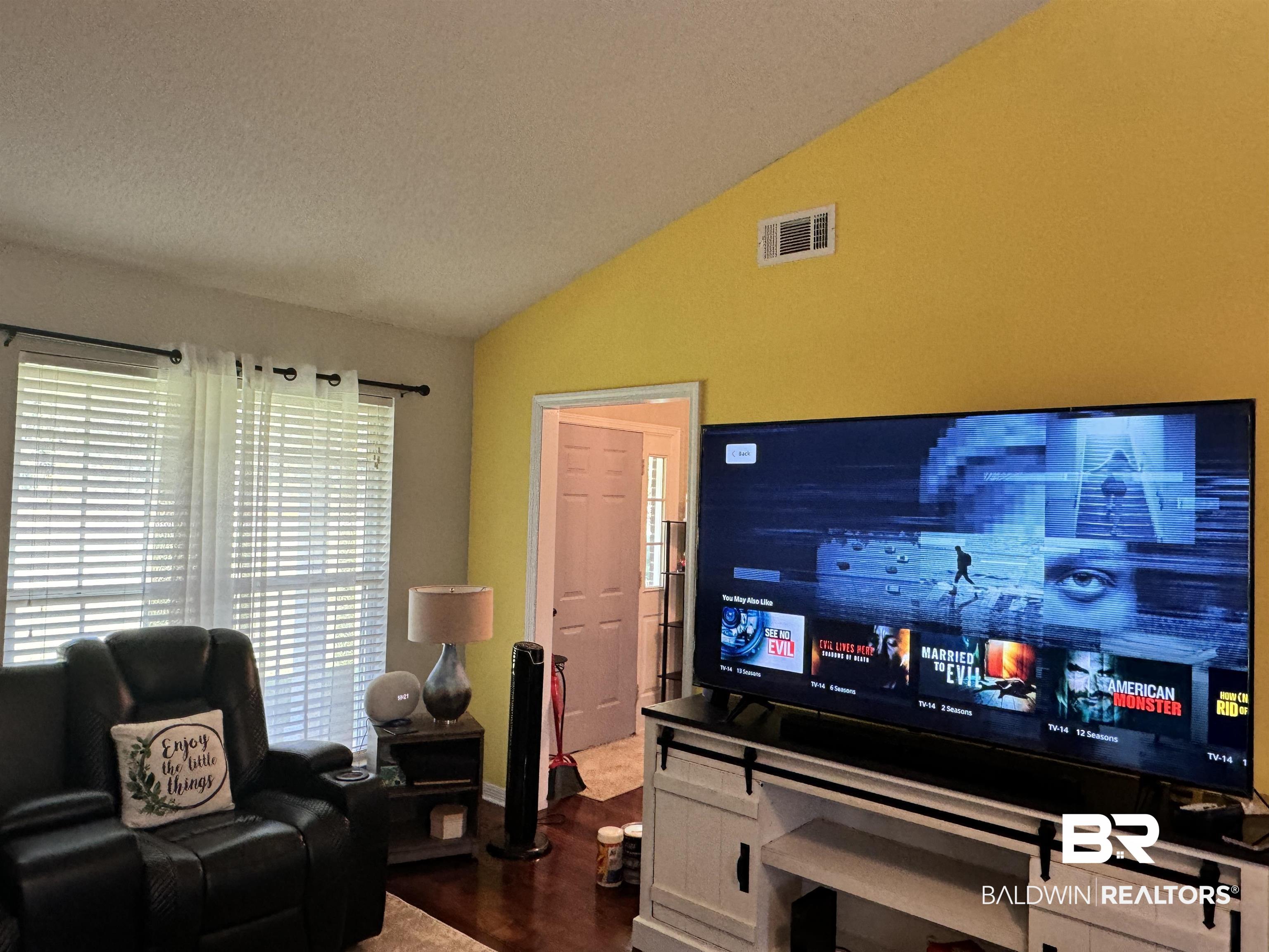 14313 Hemley Road Coden, AL 36523 - Photo 6 of 44 Living room featuring a textured ceiling, lofted ceiling, and hardwood / wood-style floors